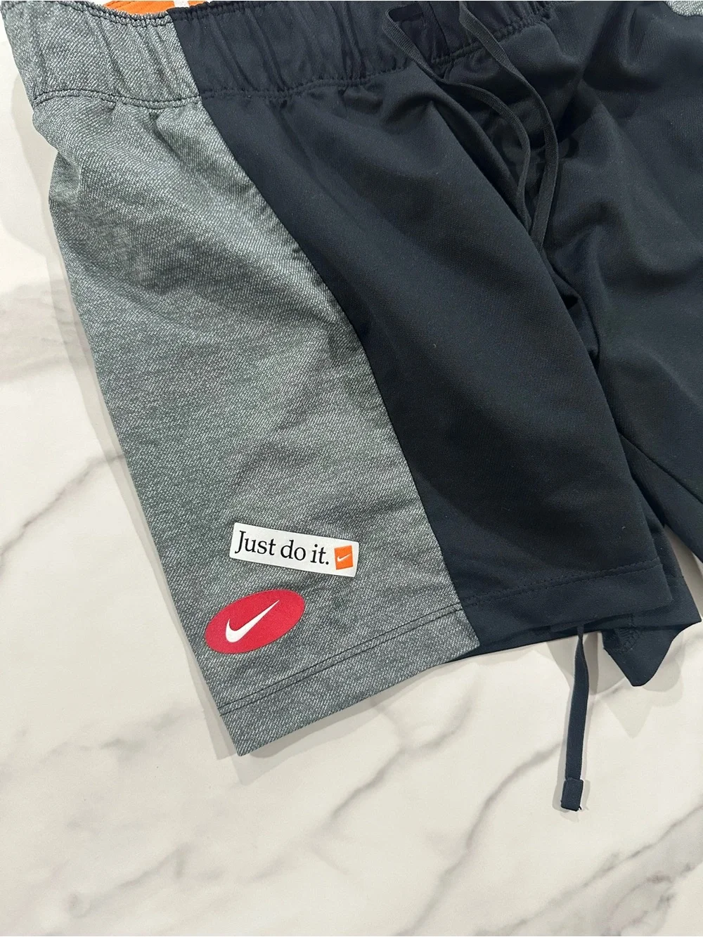 Nike Black Athletic Shorts with Gray Panels and Orange Waistband